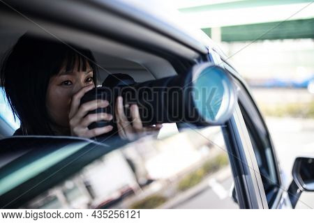 Woman Taking Pictures From Inside The Car