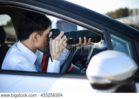 A Man Taking A Picture From Inside The Car