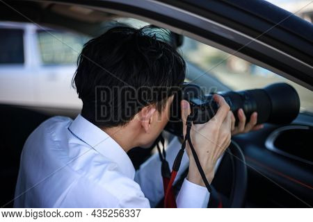 A Man Taking A Picture From Inside The Car