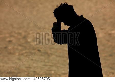 Image Of A Man Holding His Head