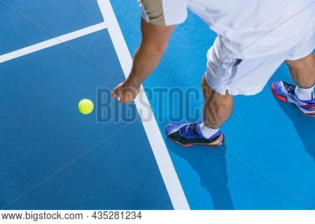 Cropped Immage Of Male Tennis Player Preparing To Serbe A Ball Isolated Over Gym Background