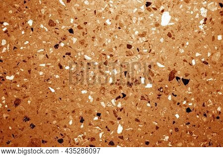Cement Plate With Small Gravel Stones In Orange Tone. Abstract Background And Texture For Design.
