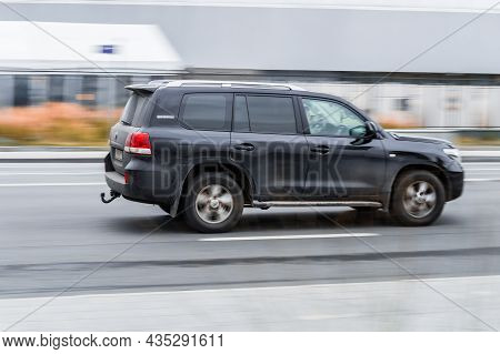 Fast Moving Black Toyota Land Cruiser 200. Suv Car On Urban Road In Motion. Overspeed In City Concep