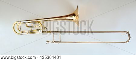 Trombone With Transposer Mounted On A White Table. Top View. Horizontal Composition.