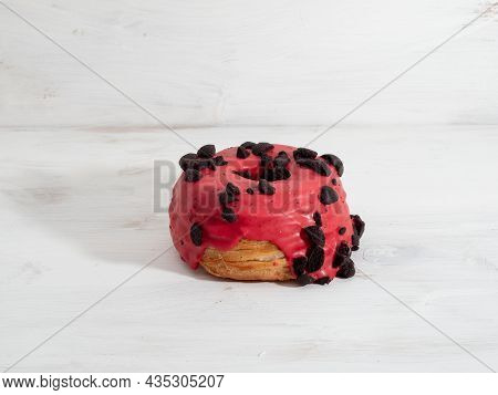 Red Cronuts On A White Wooden Background. High Quality Photo