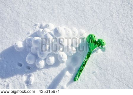 A Children Toy Is A Tool For Modeling Snowballs From Snow. Green Color Plastic Device. Winter Outdoo