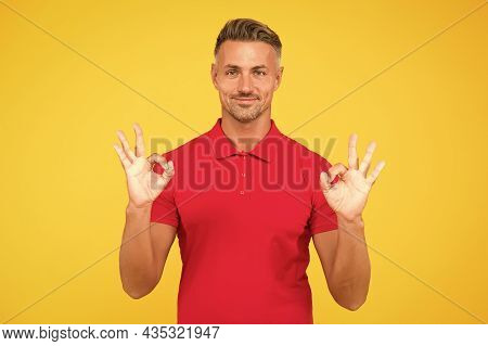 Satisfactory Result. Happy Man Show Double Ok Signs Yellow Background. Satisfied Guy Smile With Sati