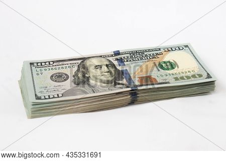 A Stack Of Hundred-dollar Bills On A White Isolated Background. 100 Dollar Bills