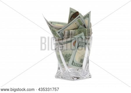 A Pile Of Dollars In A Whiskey Glass On A White Isolated Background. Retirement Savings In Dollars. 
