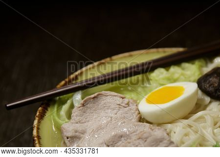 Asian Soup With Boiled Egg Mushrooms And Noodles And Hasi Sticks