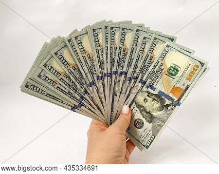 A Bunch Of Dollars In The Hands Of A Close-up. The Background Is Made Of Dollars. Isolated Dollars