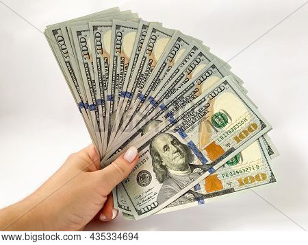 A Bunch Of Dollars In The Hands Of A Close-up. The Background Is Made Of Dollars. Isolated Dollars