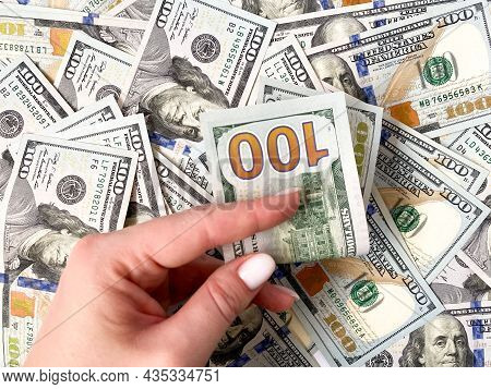 A Bunch Of Dollars In The Hands Of A Close-up. The Background Is Made Of Dollars. Isolated Dollars