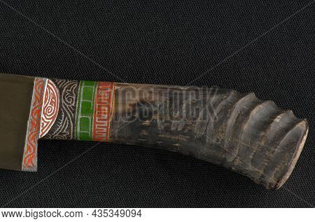 Decorative Oriental Knife On The Black Background. Bone Handle