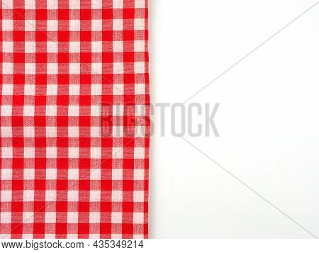 Top View, Close-up Of Red And White Checkered Fabric Or Napkin On White Table Background. Concept Ki
