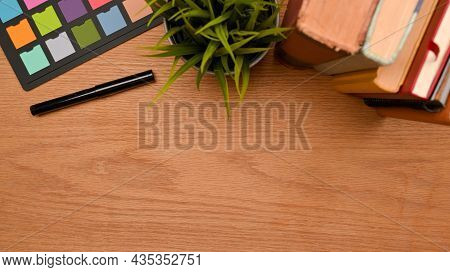Top View Of Simple Workspace On Wooden Table With Copy Space For Montage, Stack Of Books, Colour Che