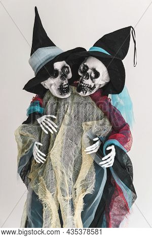 Two Funny Human Skeletons, Friendly Hugging Each Other, Ghosts In Rags And Hats. Halloween Concept. 