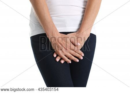 Young Sick Woman Holds Hands Pressing To Perineum To Lower Abdomen