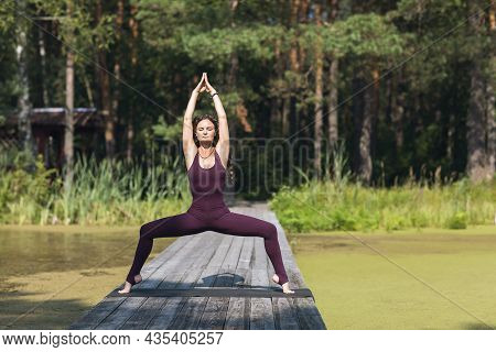 Woman In Sportswear Practicing Yoga, Performing Utkata Konasana, Goddess Pose, Exercising Outdoors I