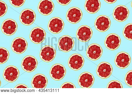 Fresh Grapefuit Slices Seamless Pattern Over Blue Background, Top View