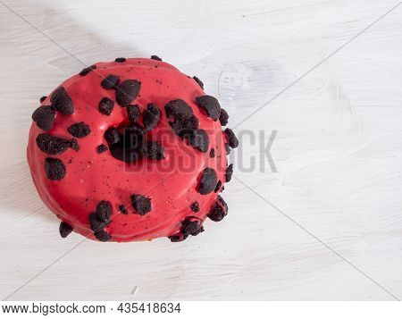 Red Cronuts On A White Wooden Background. High Quality Photo