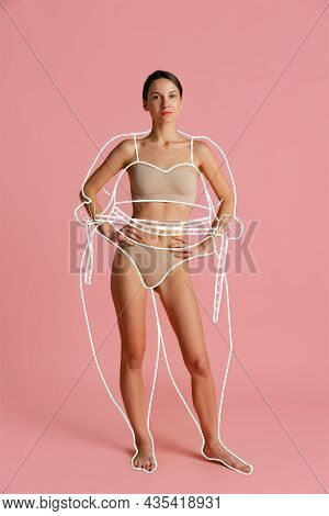 One Young Beautiful Slim Woman In Lingerie Isolated Over Pink Background. Line Art. Modern Artwork. 