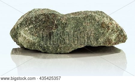 A Rough, Untreated Piece Of Jadeite On A Light Background
