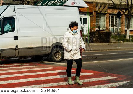 Pedestrian Crossing The Streed Using The Zebra Crossing In Bucharest, Romania, 2021