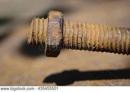 Old Rusty Bolt, Iron Rod With Screw Threads. Rusted Mechanical Components. Threaded Bolt And Nut Iso