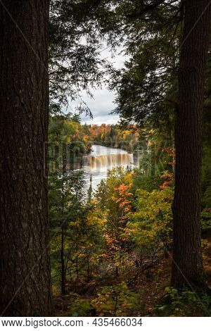 Beautiful Autumn Photograph Of Upper Tahquamenon Falls In Michigan With Water Cascading Into The Riv