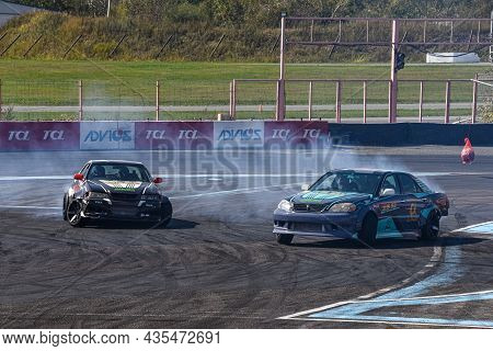 Vladivostok, Russia - October 02: Two Cars Drift, Sports Cars Wheel Drifts And A Lot Of Smoke On The