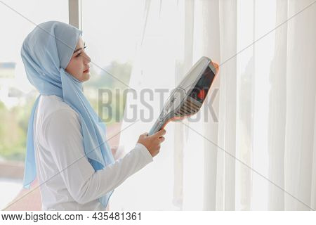 Active Young Beautiful Asian Muslim Housewife Woman Cleaning White Curtain With Vacuum Cleaning Clea