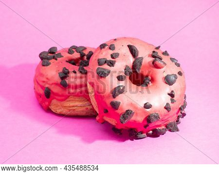 Red Cronuts On A Pink Background. High Quality Photo