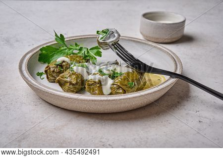 Close Up Dolma, Stuffed Grape Leaves With Rice And Meat In Light Plate With With Sour Cream, On Blac