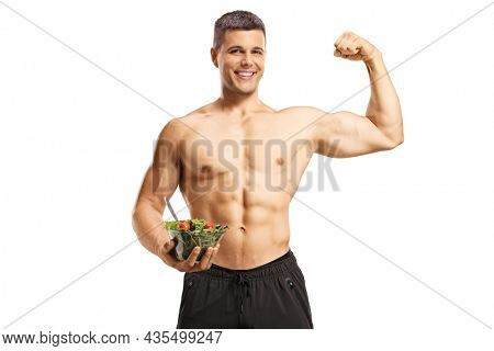Shirtless musuclar man holding a salad and flexing muscle isolated on white background