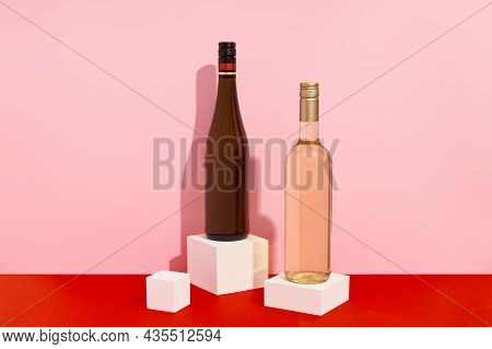 Bottles Of Wine On Red And Pink Background With Deep Shadows. Mock Up Drink With Place For You Lable