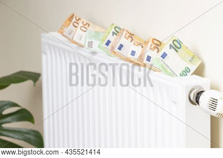 Expensive Heating Costs. Paying Bills. Euro Money Banknotes On Heating Radiator Battery With Tempera