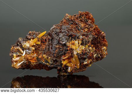 Macro Mineral Wulfenite Stone On A Black Background Close-up