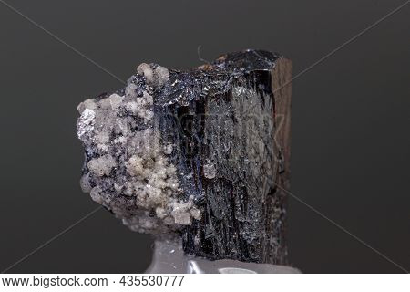 Macro Mineral Acanthite Stone On A Black Background Close-up