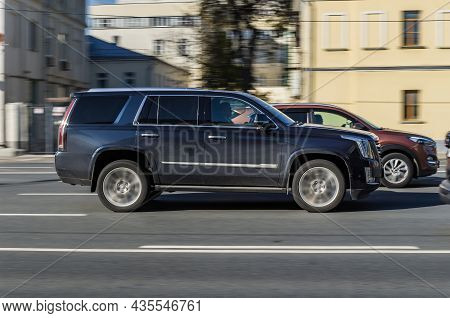 Fast Moving Cadillac Escalade On The City Road. Black Suv With Man Driving. Premium Auto In Fast Mot