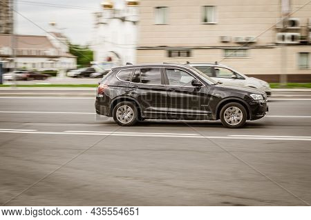 Black Bmw X3 F25 Suv Car On The City Road. Fast Moving Vehicle On Moscow Streets. Dirty And Dusty Au