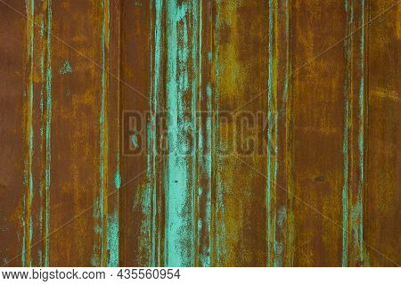 Rusted Corrugated Steel Sheet With Leftovers Of Decayed And Washed Out Green Paint.
