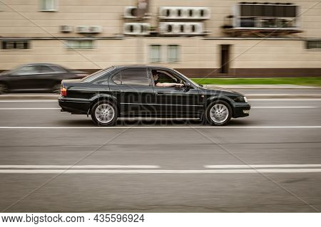 Old Toyota Camry V40 Rolling Shot Down The Street On High Speed. Black Shiny Car Toyota Vista Rushes