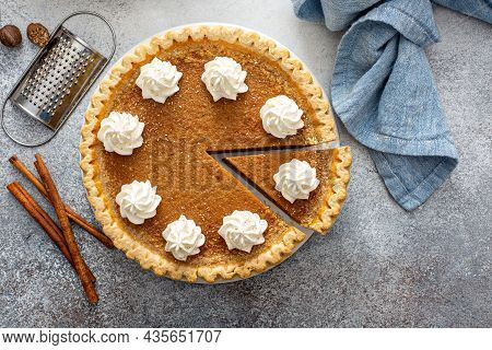 Traditional Pumpkin Pie With Whipped Cream And Cinnamon