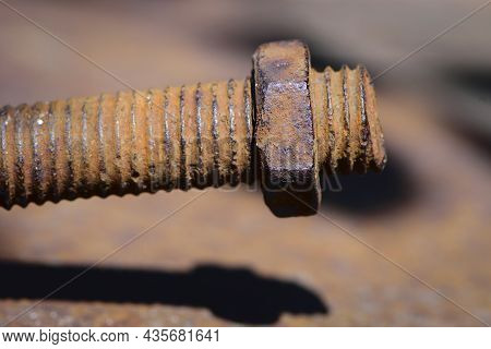Old Rusty Bolt, Iron Rod With Screw Threads. Rusted Mechanical Components. Threaded Bolt And Nut Iso