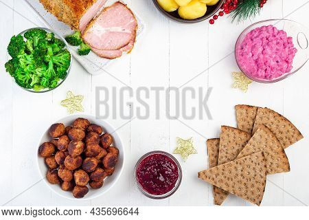 Christmas Table With Baked Ham, Beet Salad, Whole Grane Crackers, Meatballs With Lingonberry Jam