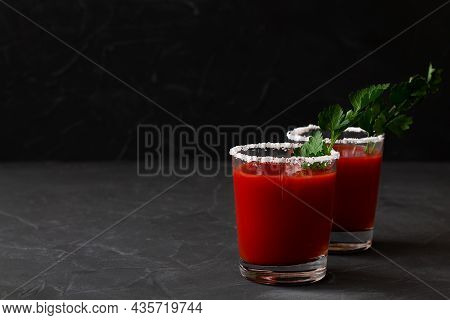 Two Glasses With Tomato Juice With Pepper, Spices, Salt And Ice In Glass With Copy Space. Bloody Mar