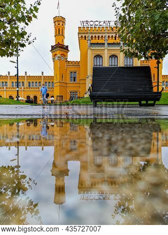 Wroclaw, Poland - September 25 2020: Old Building Of Main Railway Station Reflected In Small Puddle