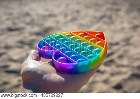 Colorful Antistress Sensory Toy. Pop It Kids Game In Hand. Outdoor Games For Children. Bright Multi-