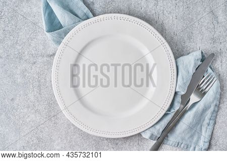 Empty White Ceramic Plate On Light Background. Clean Tableware. Serving Preparation. Nobody, Above D